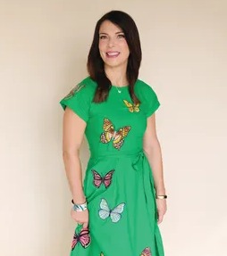 A photo of woman in green butterfly dress
